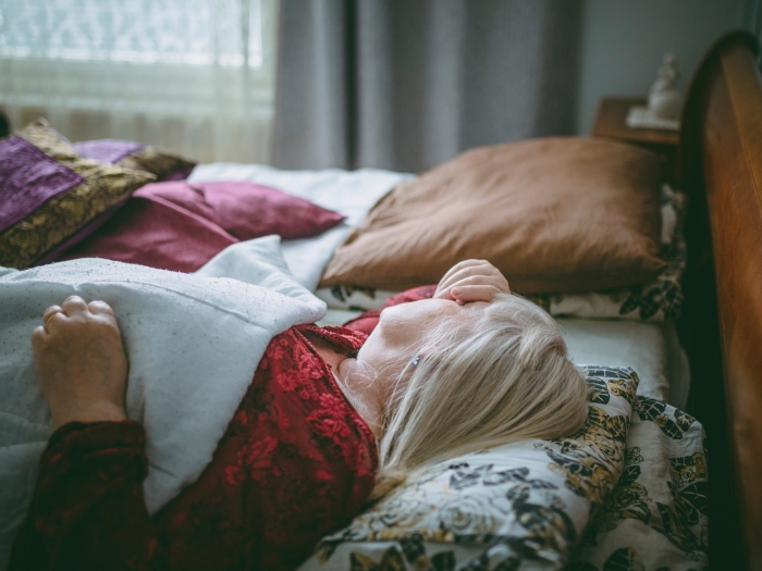 older woman lying in bed