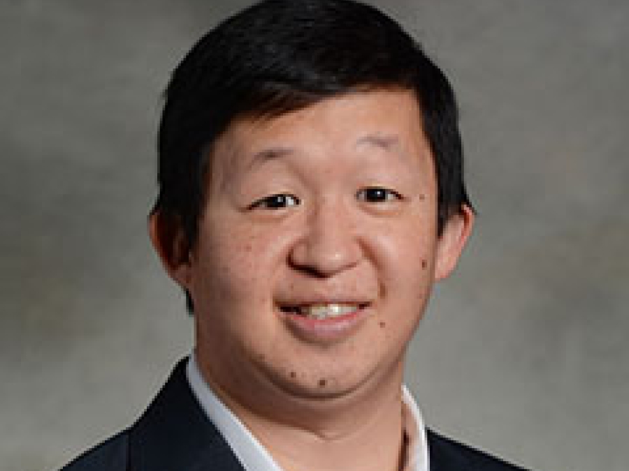 Smiling portrait of Steven Huang, M.D. He has short dark hair and is wearing a black jacket.